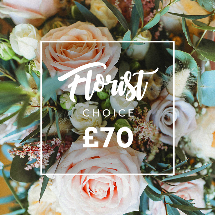 An elegant, close overhead portrait of a premium florist's selection: a hand-tied bouquet overflowing with soft pastel roses, airy fillers and tactile, natural accents. The focal blooms are large, fully opened roses in warm blush pink, creamy white and soft peach tones, petals layered like silk; scattered among them are subdued lavender-hued roses that introduce a gentle contrast and visual depth. Delicate sprays of tiny white and pale pink filler flowers-think gypsophila or waxflower-peek through the larger heads, creating a filigree of detail, while fluffy dried elements in cream and tan, perhaps grasses or seed pods, add rustic volume and a pleasing papery texture. The generous greenery, led by distinctive rounded eucalyptus leaves in a dusty blue-green, frames and supports the blooms, offering a cool, fresh backdrop and a subtle menthol-like scent. The bouquet is bathed in soft, natural light that caresses the petals and casts a romantic, shallow-focus blur at the edges. Over the centre of the floral display sits a neat white outline containing promotional text: a flowing script reading 'Florist Choice' with a smaller uppercase 'CHOICE' underneath, and the price '?70' set in bold type at the bottom of the frame-clear and visually anchored against the flowers. The overall mood is refined yet approachable, perfect for Mother's Day, an anniversary, or an elevated birthday present. It suggests careful hand selection and artisanal tying reminiscent of the bouquets you might spot in local Stanmore shops or offered to customers browsing near Stanmore Broadway and the high street cafés.