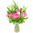 A luminous, carefully composed bouquet of deep pink roses and white lilies sits in a clear glass vase, photographed against a clean white background so every petal and leaf reads vividly. Several large roses dominate the centre, their velvety petals unfolding in layered waves of fuchsia and blush that catch soft, even light; their scent is suggested rather than shown, as if a gentle, familiar sweetness lingers in the air. Around them, tall white lily buds arc upward - some still tightly furled with pale green tips, others just beginning to open and reveal satin-white trumpets and delicate stamens, lending a poised, expectant quality to the arrangement. Rich green foliage, from broad glossy leaves to finer, airy sprigs, frames the blooms and gives the bouquet a generous, rounded silhouette; darker burgundy or reddish-brown accent buds and textured greens are woven through to add depth and a quiet contrast that keeps the eye moving. The clear vase, its rim gently flared and base solid, holds clear water through which neatly trimmed stems are visible, reinforcing the freshness and craftsmanship of the composition. The overall impression is one of considered elegance - bright, celebratory and warm - suited to a birthday, anniversary, or an uplifting gift for someone resting at home after a walk on Stanmore Common. As a florist describing this piece, I picture it brightening a kitchen table on Stanmore Broadway or arriving as a thoughtful, fragrant surprise after a morning on the Jubilee Line at Stanmore Station.