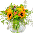 An uplifting, sun-kissed bouquet stands out against a white backdrop-a heartfelt composition crafted by a true Stanmore florist. The arrangement bursts with the glow of sunflowers; two main blooms greet the viewer, their deep brown centers framed by rows of golden petals, evoking the sunshine that bathes Stanmore High Street in summer. Interlaced are smaller yellow filler flowers, offering texture and cheerful accents, while coral-orange tulip-like blossoms peek out, providing a soft, contemporary twist. Lush ferns spill elegantly around the perimeter, their feathery texture bringing nature's tranquility indoors, enhanced by the presence of blue-green eucalyptus and fresh lime-green foliage. All is presented within a clear, globe-shaped glass vase, with every green stem visible in the pure water below-an assurance of the bouquet's freshness and quality, just as Stanmore locals expect. The arrangement beams with positivity, well-suited for birthdays, thank-you gestures, or simply to illuminate a home with Stanmore's distinctive warmth. With every petal, the bouquet seems to bring a message of sunshine and hope, wrapped in the tradition of local craftsmanship.