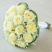 Up close, this classic bouquet for Stanmore celebrations features a tightly curving cluster of creamy white and pale yellow roses-about a dozen in number-each bud fresh, the petals plush and luminous. Between the roses, clouds of baby's breath spread an ethereal, misty softness, gently swathing the arrangement in timeless romance. Broad, dark green leaves elegantly arc around the bouquet, creating bold strokes of color that highlight the delicate flowers. To the bouquet's right, the stems are expertly bound together with pristine white satin ribbon, forming a handle that sits easily in the palm-suited for carrying along Stanmore's tree-lined avenues or as the crowning touch to a local event. The bouquet is showcased on a subtly textured, creamy backdrop, ensuring every rose and detail receives full attention. An emblem of pure love, sophistication, and Stanmore's refined tastes, this bouquet is an iconic choice for weddings, anniversaries, or anniversary gifts, thoughtfully composed with the artistry and warmth characteristic of Flowers Stanmore.