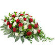A beautifully composed red and white funeral spray rests against a stark white background, its colours and contours standing out with gentle clarity. The arrangement is long and slightly crescent-shaped, beginning with a fuller, domed cluster of blooms on the left and then tapering into a more delicate, trailing point on the right. The central focus is a collection of deep red roses, their velvety petals tightly furled, each one a symbol of deep affection, respect, and cherished memory. Interspersed among them are numerous white carnations, generously packed so their fluttering, ruffled petals create a soft, cushion-like texture and a sense of quiet purity. This traditional pairing of red and white is both solemn and comforting, ideal for a sympathy tribute. Underpinning the flowers is a rich base of greenery: glossy dark green leaves give the arrangement strength and definition, while softer, silvery-green eucalyptus leaves are threaded throughout, adding depth, contrast, and a gentle, uplifting scent. From the right-hand side, finer green stems trail outward in a loose, natural fashion, completing the design with a graceful, cascading edge. The overall effect is one of calm, respectful beauty, suggesting the skilled work of a Stanmore florist preparing a memorial spray to be delivered to a local funeral home or place of worship near Canons Park or along Marsh Lane. It appears ready to be placed upon a casket or displayed beside a photograph, offering a heartfelt floral tribute from family and friends who wish to say goodbye with dignity and love.