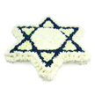 A beautifully composed Star of David floral arrangement dominates a clean white background, its detailed shape and colours clearly visible. The star is made entirely of small, multi-petalled flowers arranged so tightly that they create a smooth, padded surface with no visible stems or foliage. Most of the tribute is a cool, pure white: these blossoms form a defined outer border, trace the six points, and fill the central hexagon of the Magen David, giving the centre a peaceful glow. From each outer point, white triangular sections reach inward, almost like folded wings turning towards the heart of the star. Standing in deliberate contrast, the interlocking triangles that form the familiar Jewish symbol are packed with deep navy blue flowers. Their dark, saturated petals draw sharp, geometric lines across the white, ensuring the star's pattern is easy to read and immediately recognisable, even from the back of a chapel. The restrained palette of white and blue subtly mirrors the tones often associated with Jewish tradition and the Israeli flag, adding layers of meaning for families and friends gathering in Stanmore's well-known Jewish community. The tribute appears slightly raised, giving a three-dimensional effect that would look equally dignified laid flat on a stand or resting by the casket. Designed as a Jewish funeral or memorial tribute, it conveys respect, remembrance, and a strong sense of heritage, the kind of floral piece chosen when relatives want to honour both the individual's life and their connection to longstanding faith and custom.
