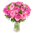 A celebratory dome of roughly two dozen fresh pink roses sits in a clear glass vase, photographed against a bright white backdrop so the colours sing. Each rose is at full, elegant bloom: tight spirals at the centre hold richer fuchsia or magenta tones that ease outward into soft blush pink and pale creamy edges. The layered petals read like satin under the gentle, even light, catching subtle highlights that accentuate every curl and fold. Scattered among the blooms, deep green glossy leaves peek through and cup the heads, offering contrast and a sense of natural structure. Through the transparent vase - slightly curved and narrowing at the middle - the neatly trimmed green stems are visible, submerged in clear water that suggests cool freshness and recent arranging. Close your eyes and you might imagine the faint, fruity-rose perfume that lifts above the bouquet, the velvety texture of each petal, and the slight hush of a morning in a neighbourhood flower market. This arrangement feels intimate yet confident, a timeless expression for anniversaries, birthdays, Mother's Day, or simply to say thinking of you. As a local florist familiar with Stanmore Village and the lanes around Stanmore Park, I picture delivering this piece down a short, familiar route - wrapped gently, still smelling of the studio - to brighten a home or bedside table. The composition balances classic romance with modern clarity: lush, structured, and unmistakably fresh, a design that invites touch and lingers in memory even after the vase is put away.
