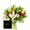 A striking bouquet unfolds with elegant simplicity, pairing the refined purity of white lilies with the passionate red of classic roses. Each lily, some opening while others remain in poised bud, sends out a gentle, sweet scent almost like a whisper of fresh spring mornings. The roses, velvety and rich, nestle comfortably among lush, vivid green foliage, their fiery presence radiating admiration and strength. Hints of eucalyptus and wispy grasses add movement and a subtle, herbal freshness. Light cascades softly over the petals, highlighting the crisp contrast between colours and the decadent texture of each bloom. Designed with gratitude and reverence, this arrangement feels like an ode to someone cherished and extraordinary, a vibrant tribute for a milestone, a heartfelt thank you, or simply to celebrate a personal hero. It rests in a clear glass vase, ready for Stanmore homes near The Broadway and Stanmore Hill, with delivery across Stanmore available the same day. The bouquet carries a message of respect and admiration, and the card marked Hero cements its purpose as a thoughtful gesture to honour strength and resilience in a loved one or colleague. From a Stanmore florist perspective, the pairing of pure white and deep red offers a timeless appeal that resonates across generations, a reliable expression of appreciation that endures.